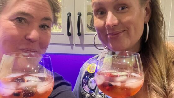 Photo of Becca and Vanessa holding cocktails