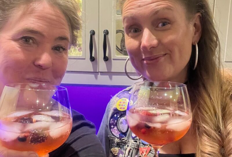Photo of Becca and Vanessa holding cocktails