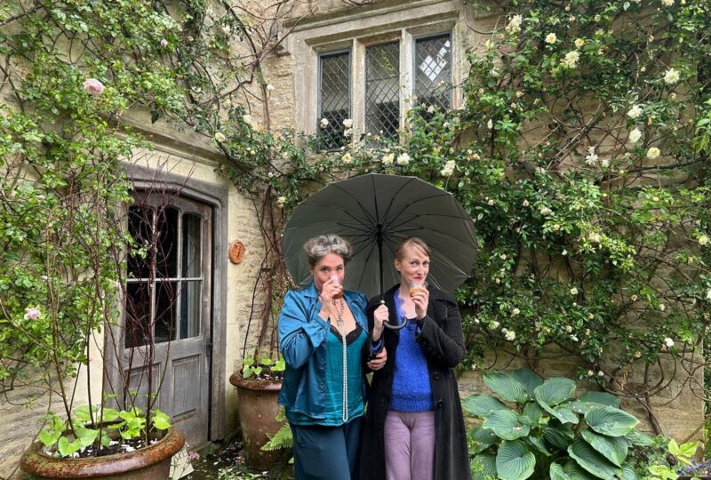 Rebecca Mordan and Emer O Connor drinking cocktails outside Asthall Manor